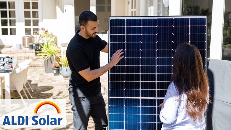 Man and woman looking at solar panel